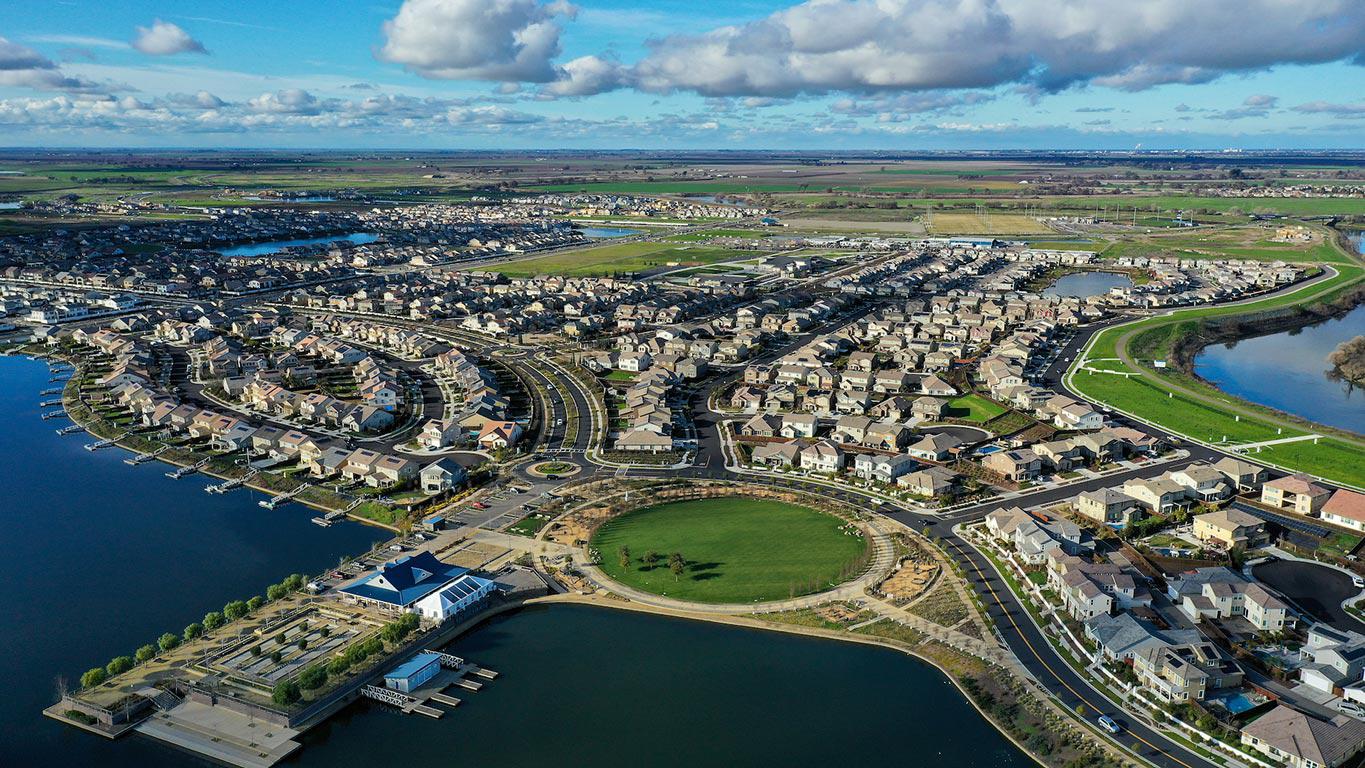Aerial view of River Islands, with finished neighborhoods along the water and new phases still going up
